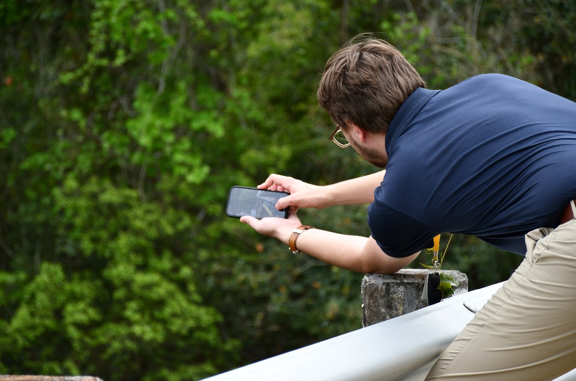 Justin photographs a bridge during a reporting assignment.