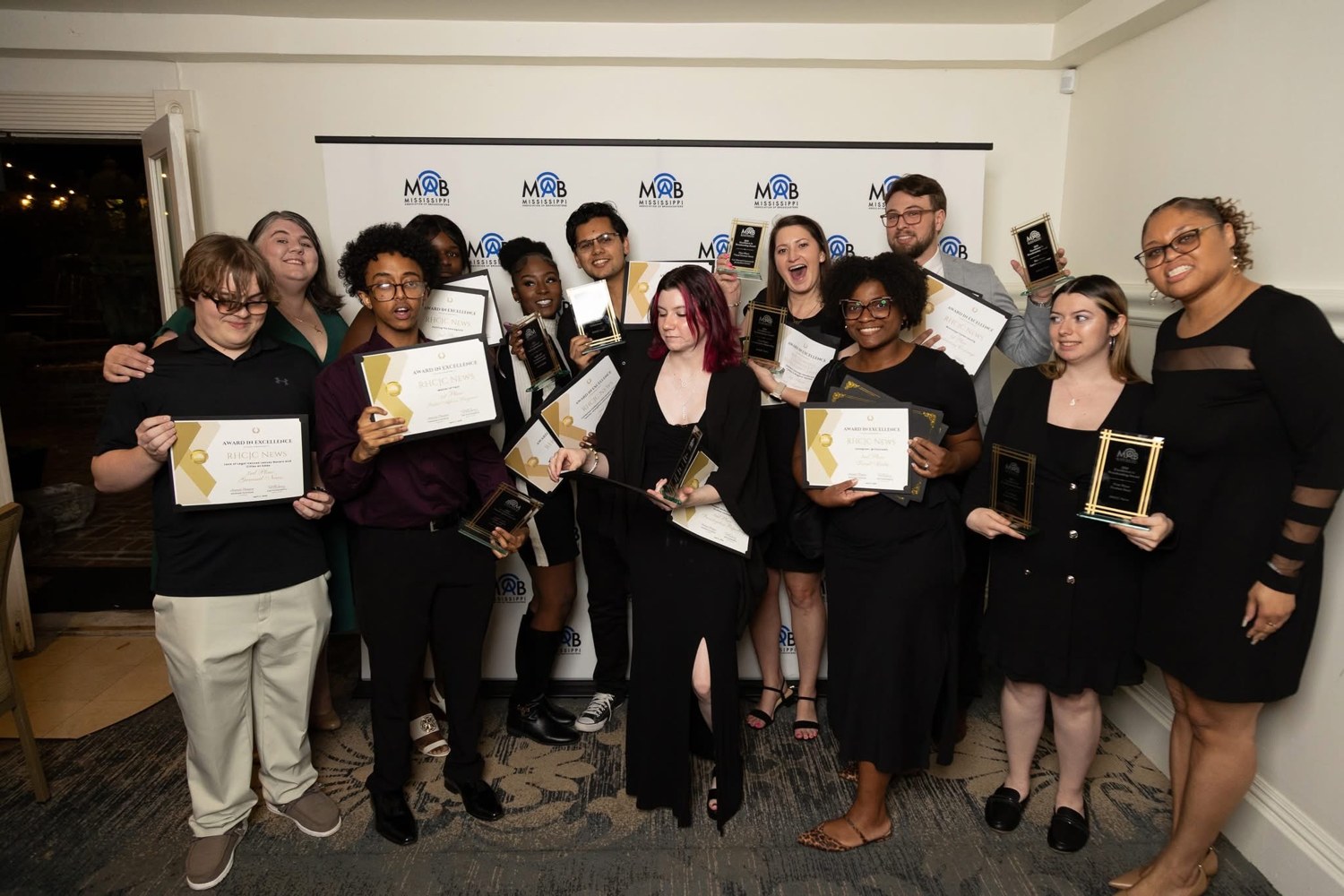 RHCJC colleagues together with certificates and trophies.